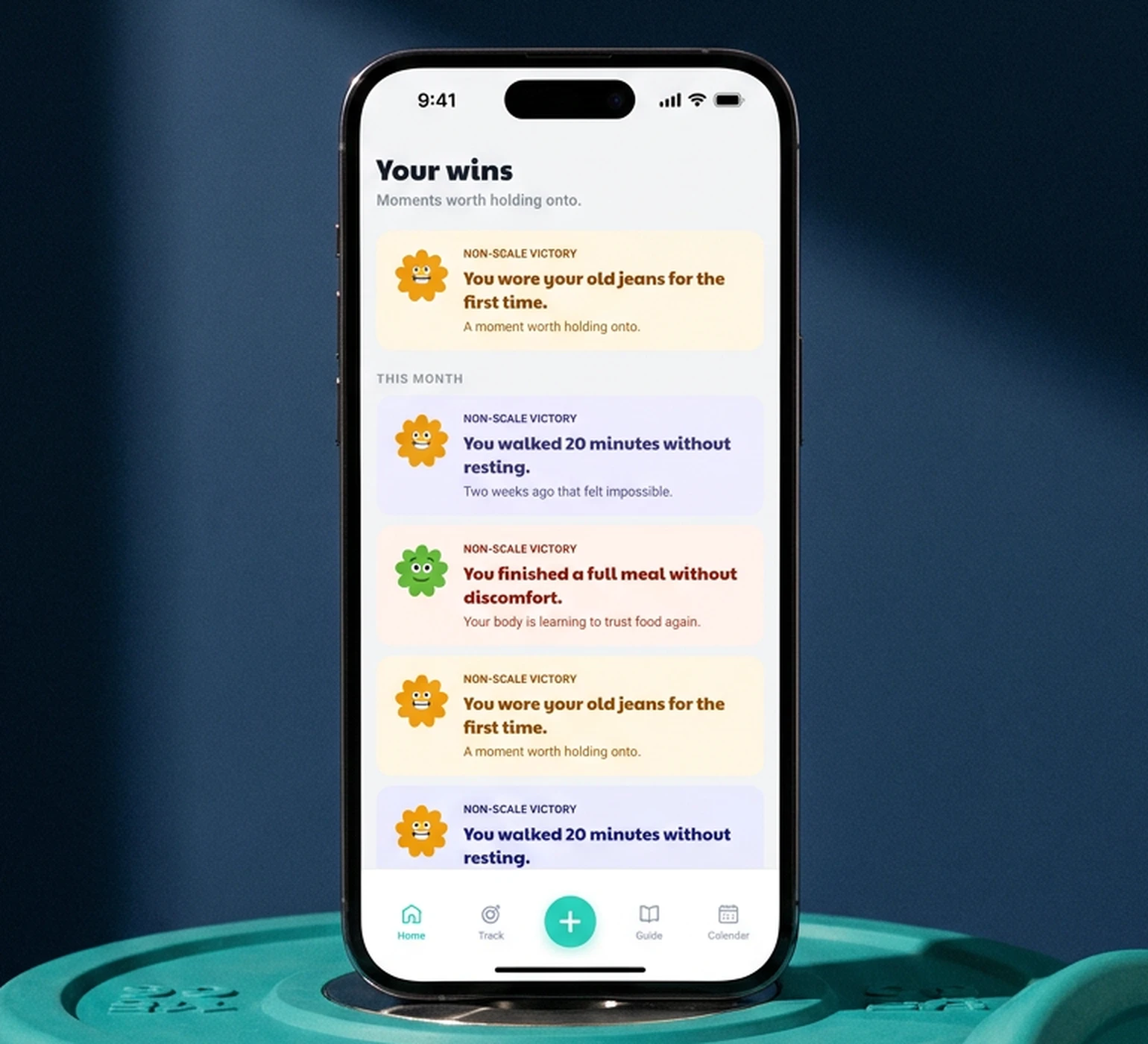 A non-scale win, logged: the phone resting on teal bumper plates